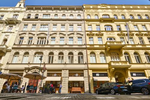 a large building with cars parked in front of it at Residence Dlouha - Old Town in Prague