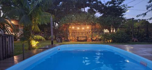 a swimming pool in a yard with a gate at Espaço Sairé - 8 minutos da Praia in Alter do Chao
