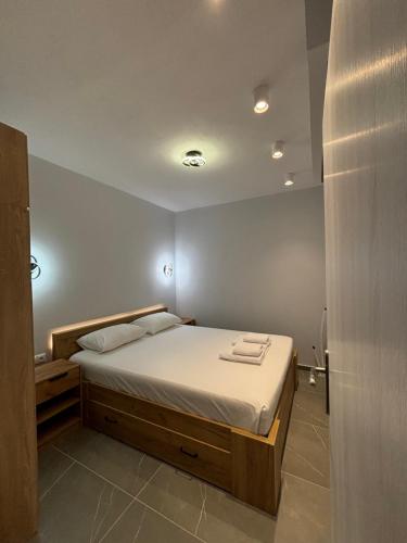a bedroom with a large bed with towels on it at Manis apartment in Prinos