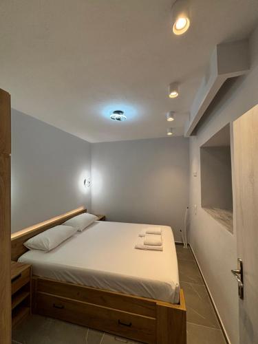 a bedroom with a bed with white sheets at Manis apartment in Prinos
