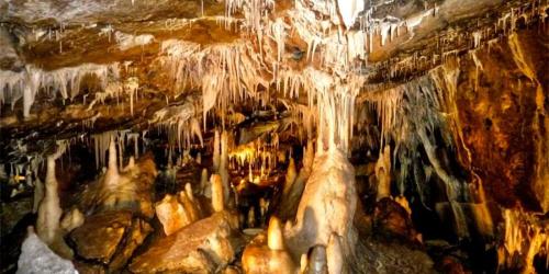 a cave with icicles on the walls of it at Bačova drevenica in Liptovský Ján
