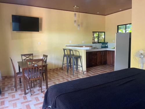 a kitchen with a table and chairs and a kitchen with a refrigerator at Villas Casa Paz in Cóbano