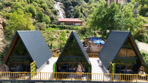 a slide at a amusement park with mountains in the background at AĞARAN Wooden Houses 2 in Cayeli