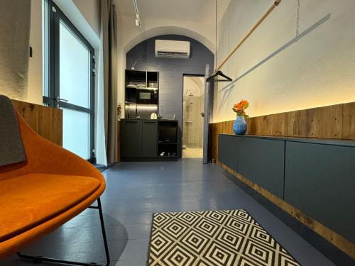 a living room with a couch and a vase of flowers at Bratislava center - blue apartment in Bratislava