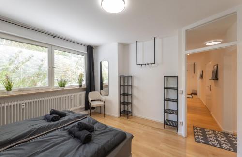 a bedroom with two beds and a large window at SweetHome - Küche, Stellplatz, WLAN, Nähe S-Bahn in Munich