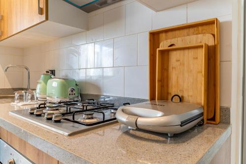 a kitchen with a stove with a toaster on it at AeroHarmony in Nouaceur