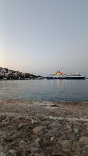 a large cruise ship in the water with a beach at Seaside Breeze Apartment in Sitia