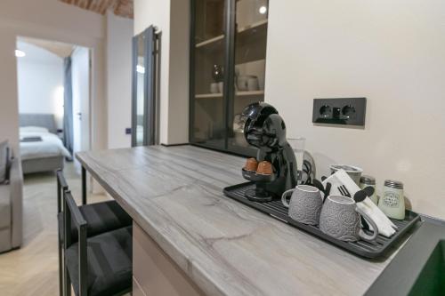 a kitchen counter with a tray with cups on it at Biagio Boutique Studio - in Old Town - Ultra Central in Braşov