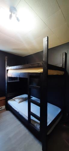 two bunk beds in a room with a ceiling at The International House Hostel in Quebec City