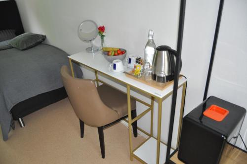 a desk with a chair next to a bed at långstorp in Höör