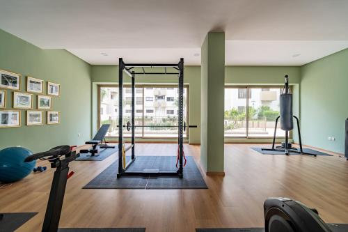a gym with treadmills and exercise equipment in a room at AeroHarmony in Nouaceur