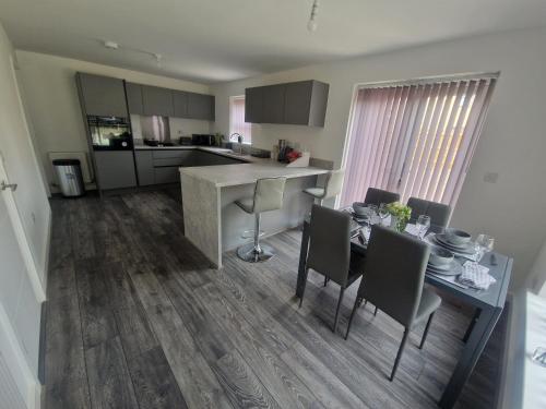 a kitchen and dining room with a table and chairs at Sweet Peace Home in Leeds
