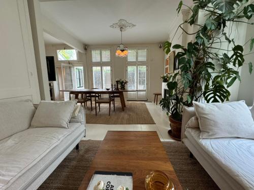 a living room with two couches and a table at WS77 B&B Apartment in Leiden