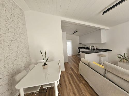 a living room with a white table and a couch at Sunflower Castle View in Óbidos in Óbidos