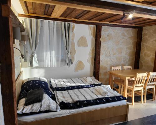 a bed in a room with a table and a tableablish at Murter Palms Resort Apartments in Murter