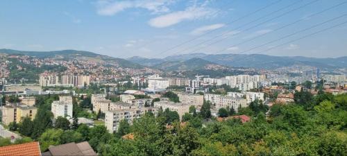 a view of a city with buildings and mountains at Apartman Dženix in Sarajevo