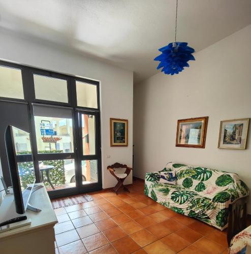 a bedroom with a bed and a tv and a window at Maisonette Asfodelo in Palau