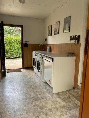 a kitchen with a washer and dryer at Nygade 42 in Skærbæk
