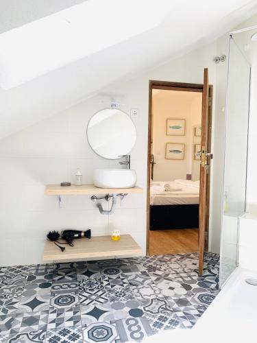 a bathroom with a sink and a mirror at RA PARAISO in Lisbon