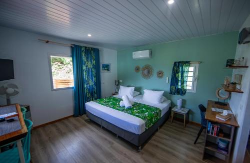 a bedroom with a bed in a room with blue walls at Morning Sun Place Tahaa in Taha’a