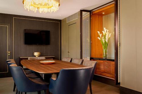 a dining room with a wooden table and chairs at The Alexander, a Luxury Collection Hotel, Yerevan in Yerevan