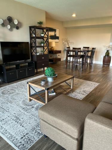 a living room with a couch and a table at Spacious 2 Bedroom 2 Bathroom Apartment with Balcony in Uptown Charlotte! City Views & Free Parking! in Charlotte