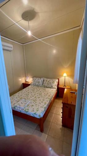 a small bedroom with a bed in a room at Little Paradise Livadi Himare in Himare