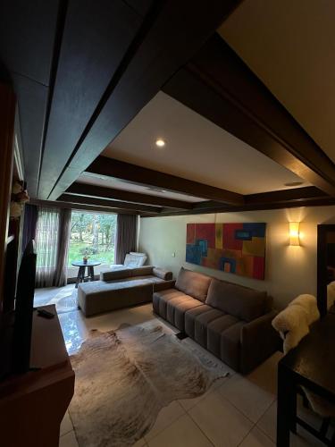 a living room with a couch and a table at Flat Luxo Mountain Village in Canela