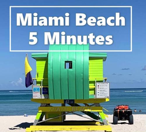 a beach life guard station on the beach with the words main beach minutes at B04 7 minutes from the beach Midtown Miami in Miami