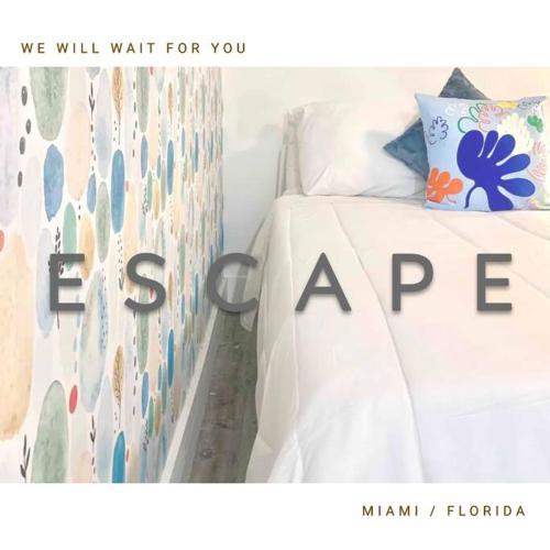 a bedroom with a bed with a white bedspread at B04 7 minutes from the beach Midtown Miami in Miami