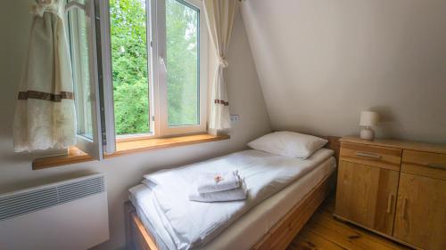 Postel nebo postele na pokoji v ubytování Dom Wakacyjny Za Zakrętem
