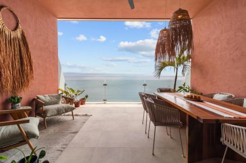 a dining room with a view of the ocean at Casa del Mar Bucerias - Beachfront Condos in Bucerías