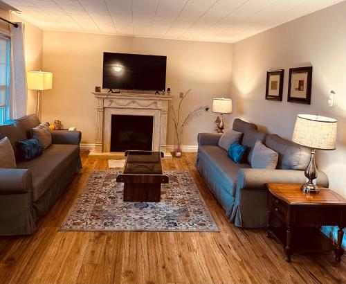 a living room with a couch and a fireplace at Lakeview Motel & Cottage in Kincardine
