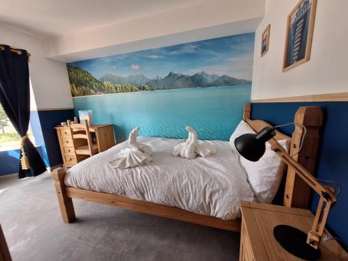 a bedroom with a bed with a painting on the wall at Sunny Waves in Northampton