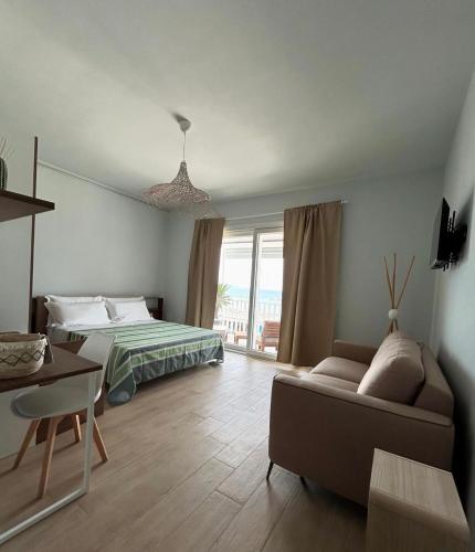 a living room with a bed and a couch at Life House B&B in Follonica