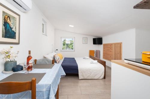a hotel room with a bed and a table and a room at Apartment Tom in Starigrad-Paklenica