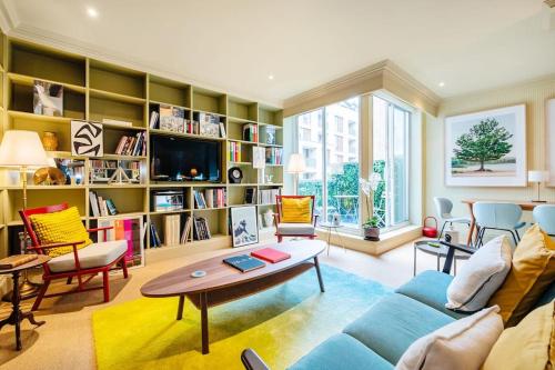 a living room with a couch and a table at Arcore London Premium Apartments in The City in London