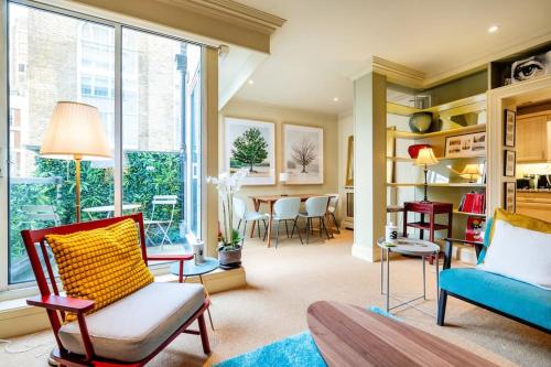 a living room with a couch and a table at Arcore London Premium Apartments in The City in London