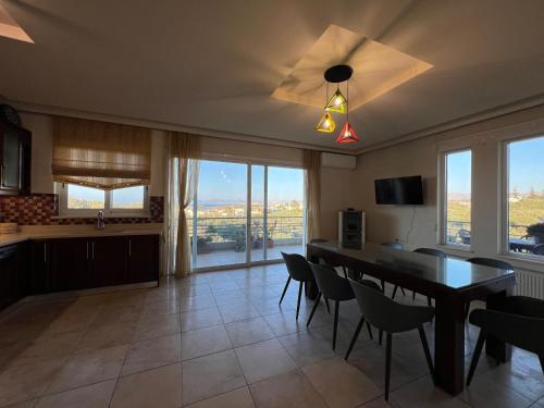 a kitchen with a table and chairs and a ceiling fan at Joyful Guest Houses by 8essentially in Chania Town