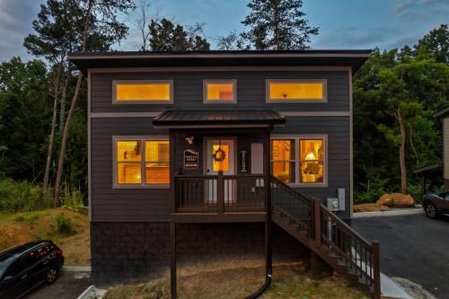 a tiny house with a large front porch at Family or couple retreat next to Downtown, Dollywood & Smoky Mountains! in Sevierville