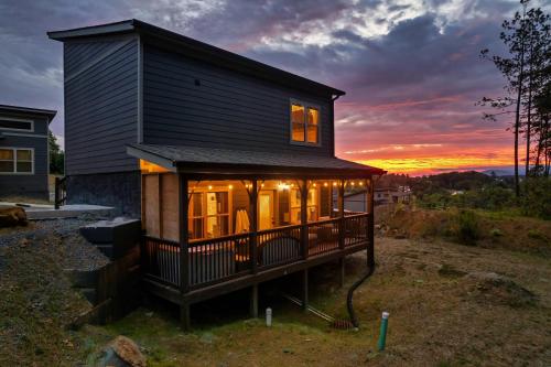 a tiny house with a sunset in the background at Family or couple retreat next to Downtown, Dollywood & Smoky Mountains! in Sevierville