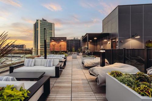 a row of white beds on the roof of a building at Luxury Apartments by Hyatus at The Asher in Stamford