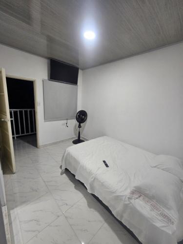a bedroom with a bed and a projection screen at La Sucursal del Cielo in Manaure Balcón del Cesar