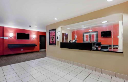 a lobby with a waiting room with red walls at Extended Stay America Select Suites - Atlanta - Clairmont in Atlanta