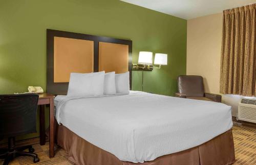 a hotel room with a large bed and a desk at Extended Stay America Select Suites - Atlanta - Clairmont in Atlanta