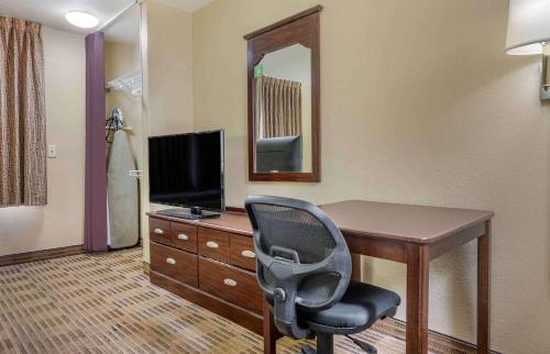 a room with a desk with a chair and a television at Extended Stay America Select Suites - Atlanta - Clairmont in Atlanta