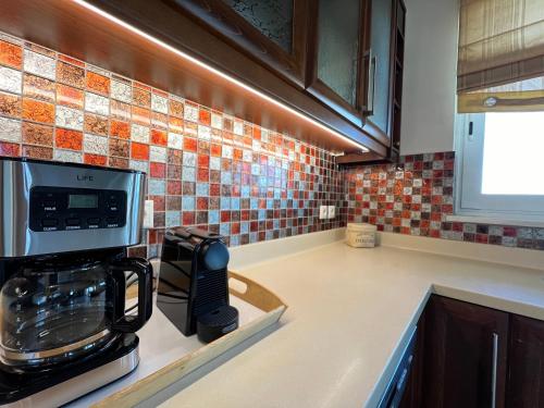 a kitchen with a coffee maker on a counter at Joyful Guest Houses by 8essentially in Chania Town