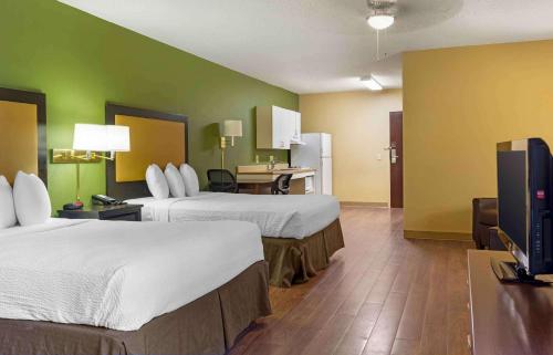 a hotel room with two beds and a flat screen tv at Extended Stay America Select Suites - Hartford - Manchester in Manchester