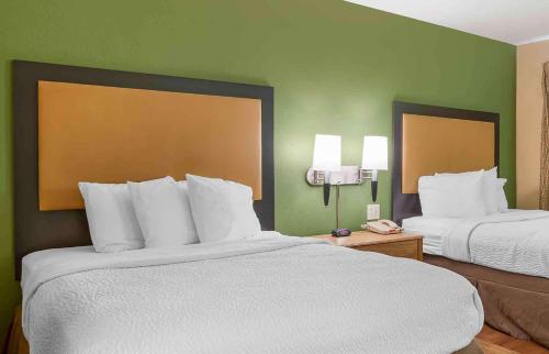 a hotel room with two beds with white pillows at Extended Stay America Suites - Fishkill - Route 9 in Fishkill