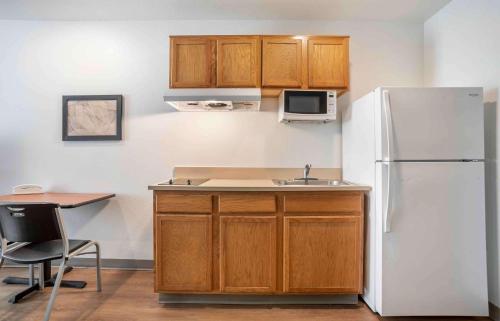 a kitchen with a white refrigerator and a sink at Extended Stay America Select Suites - Pensacola - Northwest in Pensacola